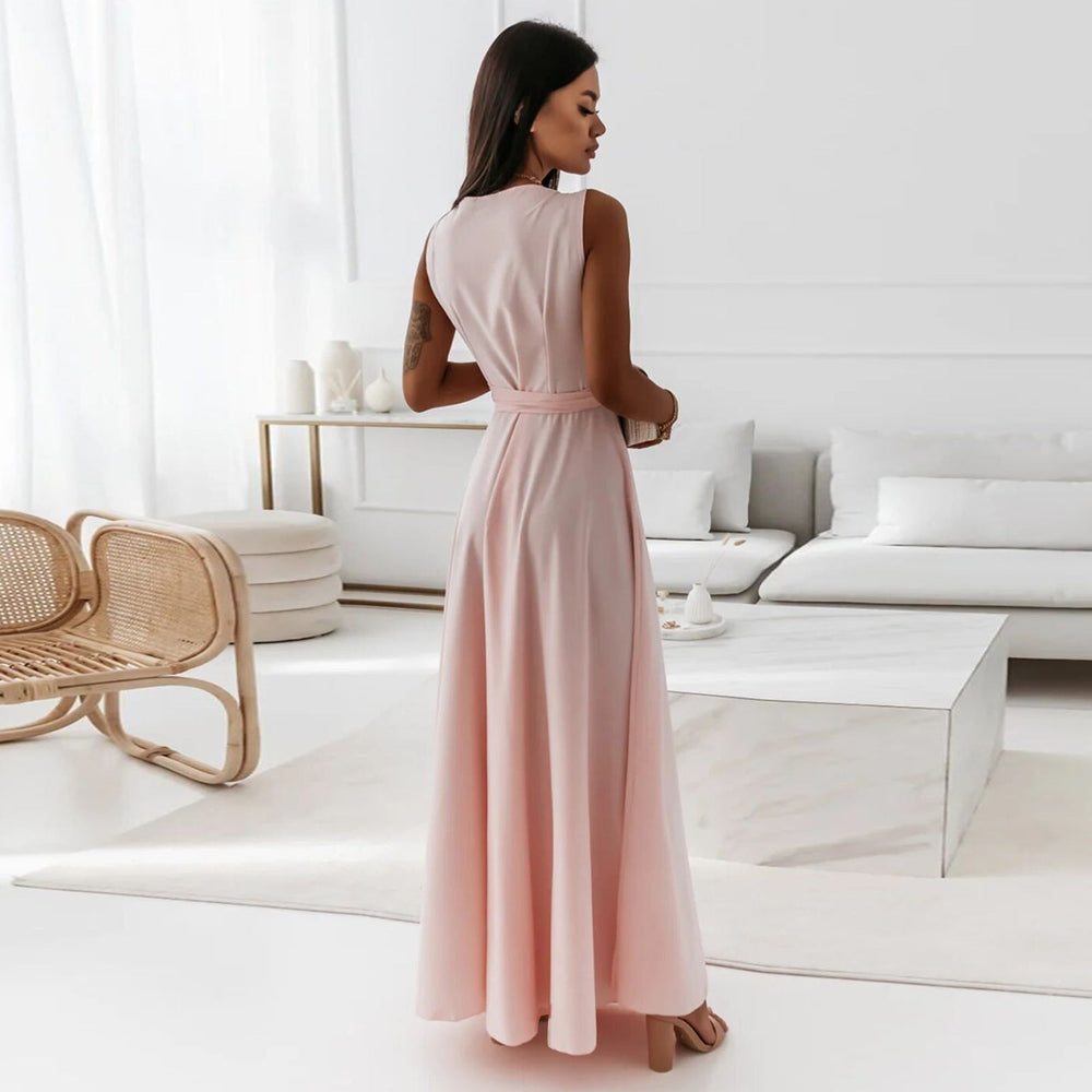 Back view of light pink V-neck sleeveless maxi dress for women, featuring a belted waist and flowing summer design.