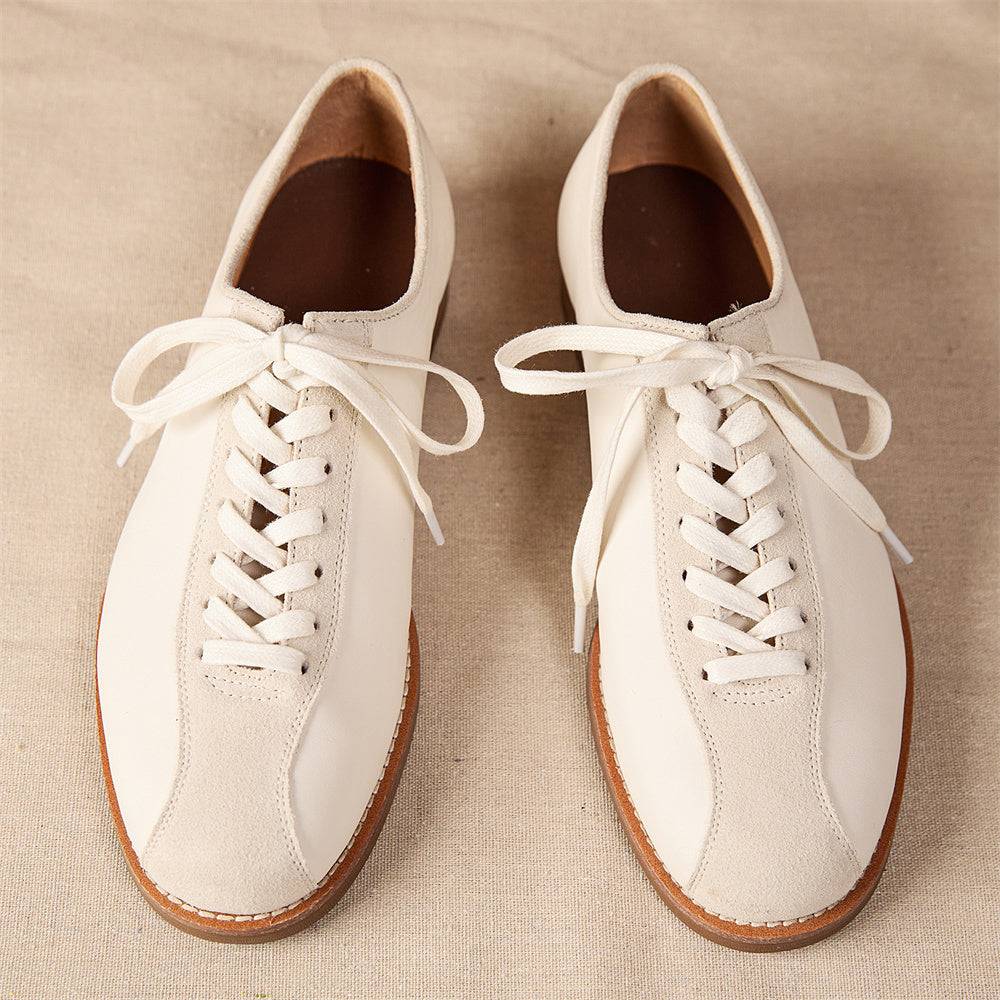 Front view of men's vintage cowhide shoes in cream leather with lace-up closure, designed for both style and long-lasting comfort.