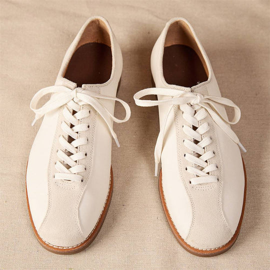 Front view of men's vintage cowhide shoes in cream leather with lace-up closure, designed for both style and long-lasting comfort.