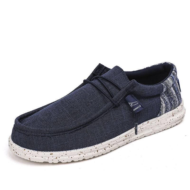 Casual navy blue men's shoes with white speckled sole, offering lightweight comfort and a relaxed, modern look.
