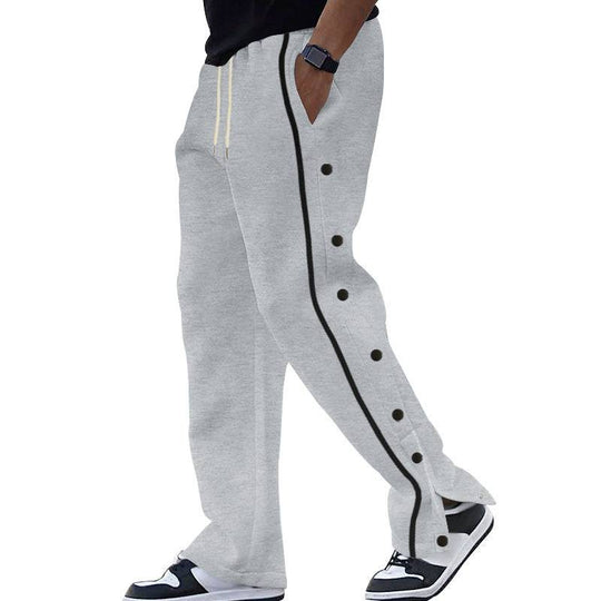 Gray men's casual sports pants featuring black side stripes and button detailing, ideal for relaxed and athletic wear.