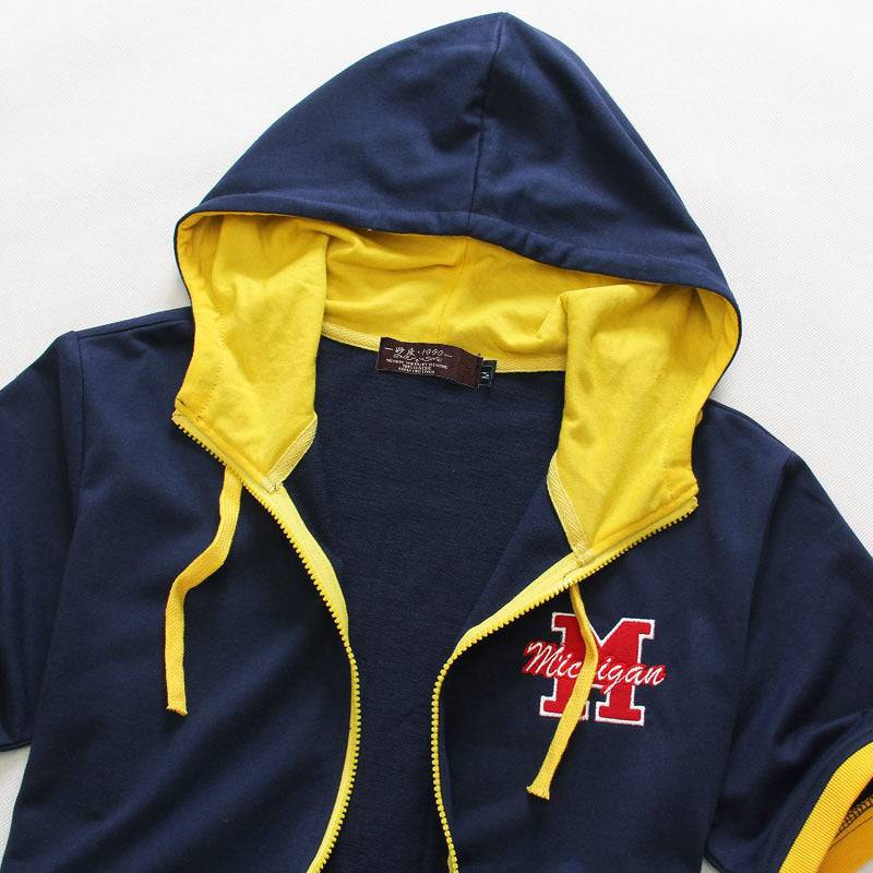 Close-up of navy men's hooded short sleeve sweater with yellow inner lining and 'Michigan' logo, ideal for sporty casual outfits.