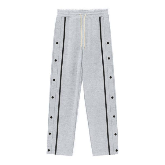 Flat-lay of gray men's casual sports pants with black side stripes and snap buttons, perfect for relaxed and athletic outfits.