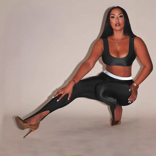 Front Step Shiny Leggings - Slim Fit Nylon Trousers in black, featuring high stretch and stirrup detail, styled with crop top and heels.