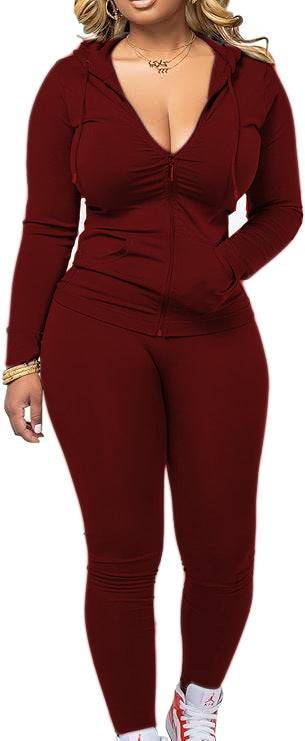 Burgundy women's fleece hoodie set featuring a zip-up top and matching leggings. Fashionable polyester outfit for casual streetwear.