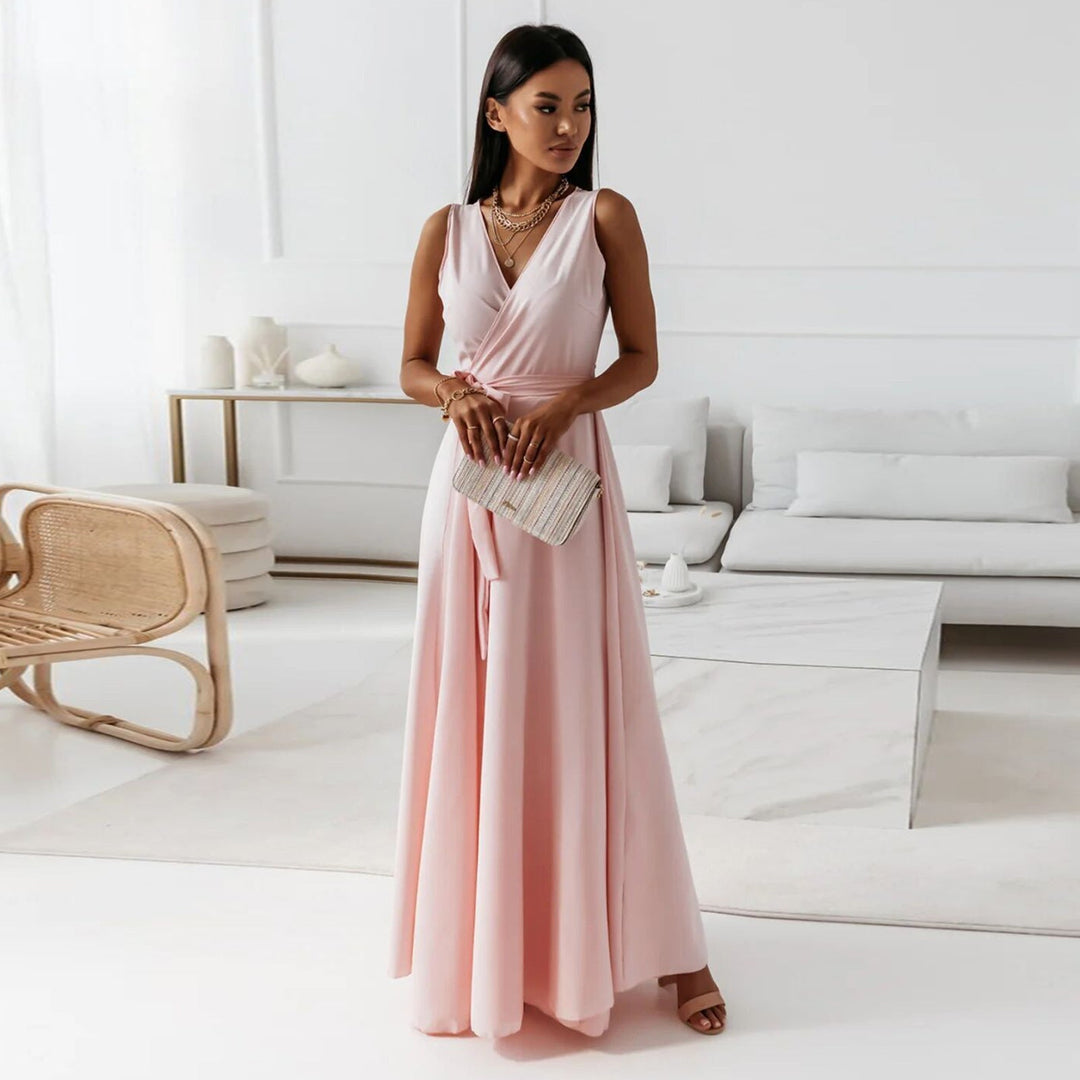 Soft pink V-neck sleeveless maxi dress with a belted waist, ideal for summer fashion and evening gatherings.