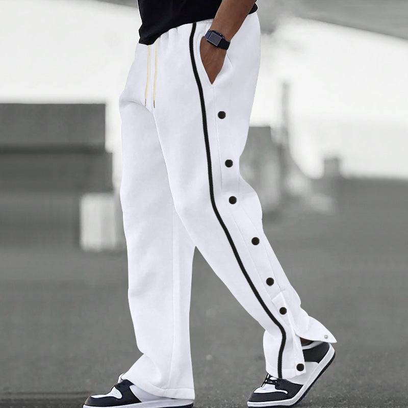 White men's casual sports pants with black side stripes and snap buttons, designed for comfort and modern streetwear style.