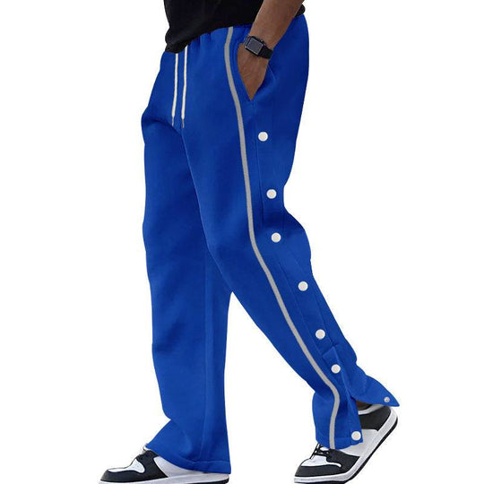 Blue men's casual sports pants with white side stripes and snap buttons, combining sporty aesthetics with everyday comfort.
