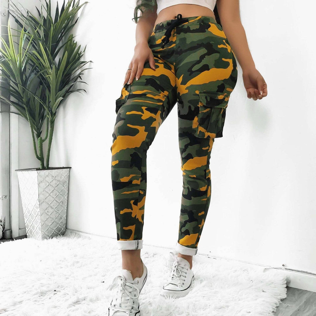 Women's plus size camo pants in yellow-green pattern, featuring a snug fit and high waist, ideal for fall-winter styling.