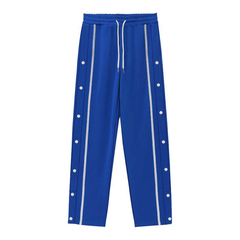 Flat-lay of blue men's casual sports pants with white side stripes and button details, ideal for sporty and casual looks.