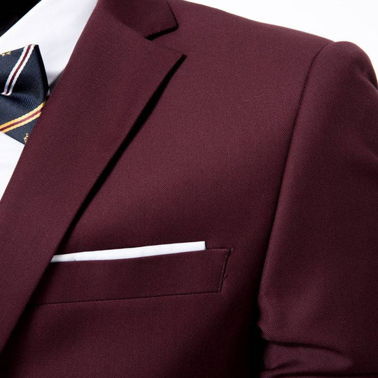 Close-up of burgundy Men's Suit Set - One Button Work All-Match showing fine fabric texture and pocket square detail.
