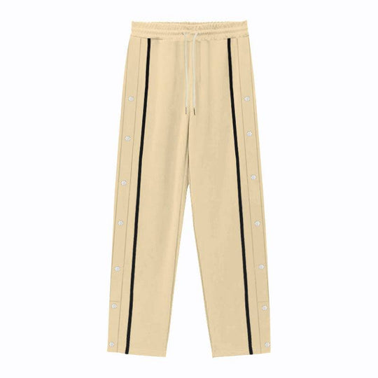 Flat-lay of beige men's casual sports pants with black side stripes and snap buttons, offering a relaxed and stylish fit.