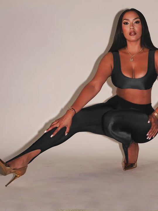 Front Step Shiny Leggings - Slim Fit Nylon Trousers in black, high-gloss finish with stirrup hem, styled with crop top and gold heels.