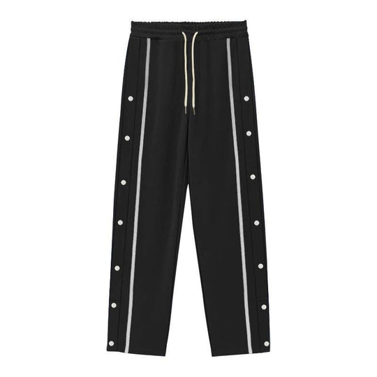 Flat-lay of black men's casual sports pants with gray side stripes and button accents, combining sleek design with comfort.